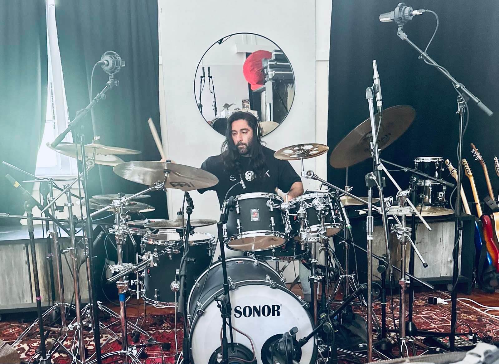 Omar recording drums in the studio.