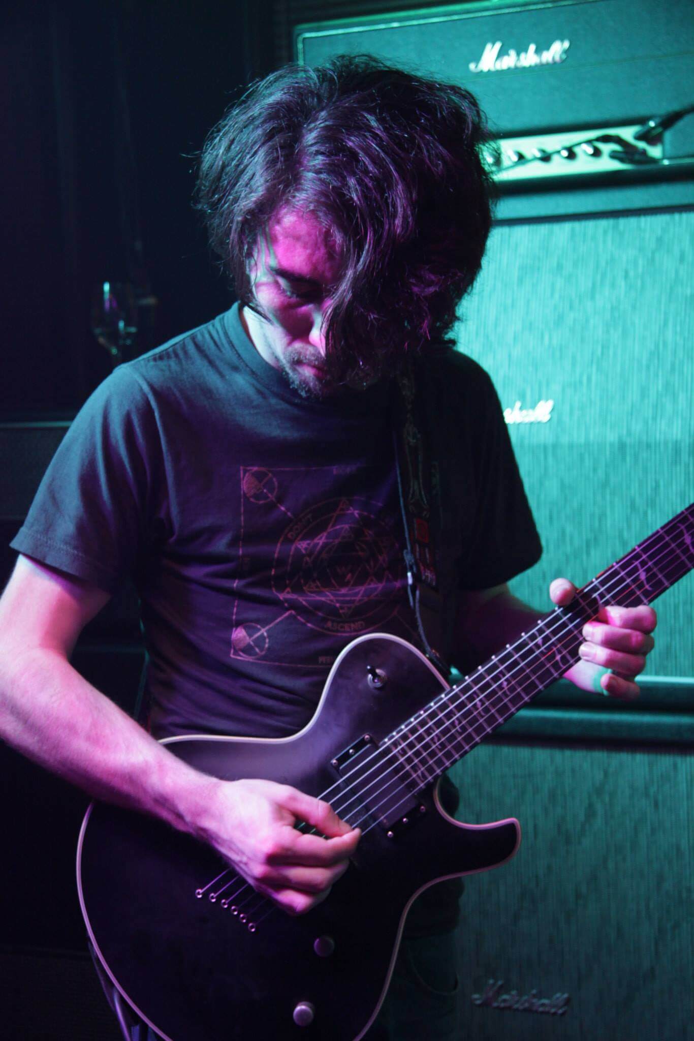 Brendan playing guitar live on stage.